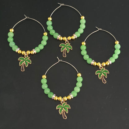 Set of 4 green and gold beaded wine glass decorations with palm tree charms