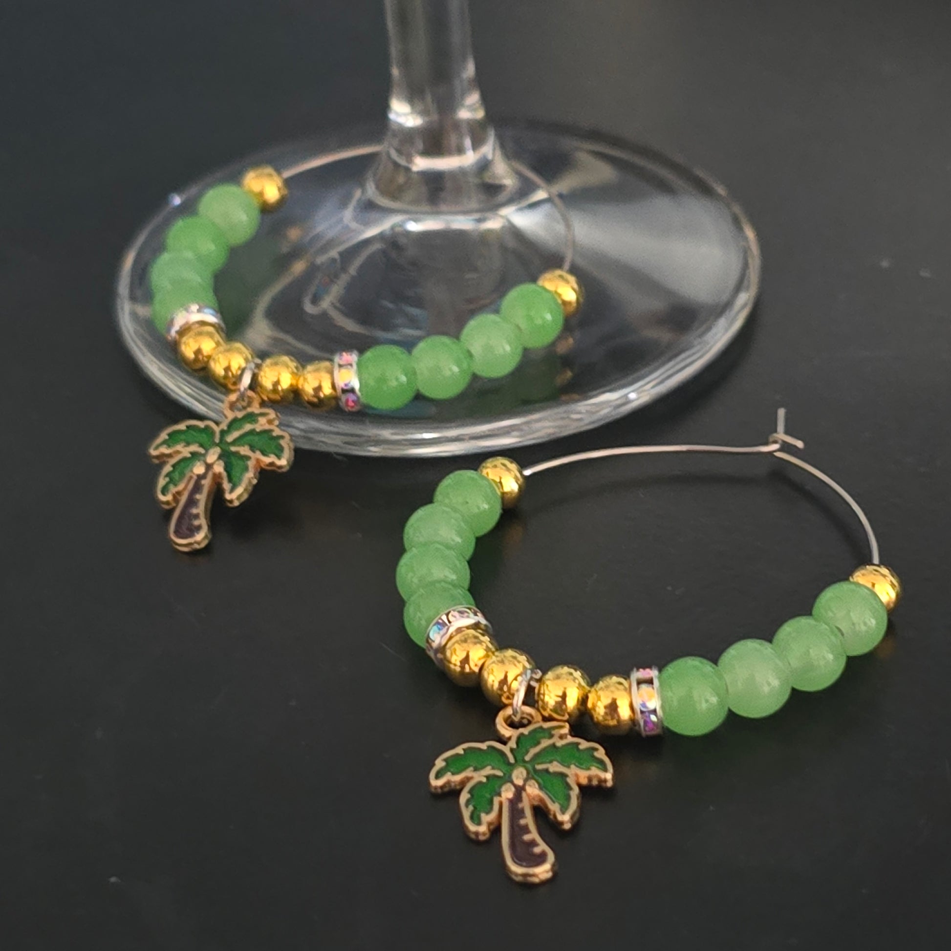 Green and gold beaded wine charms with gold accents and palm trees charms