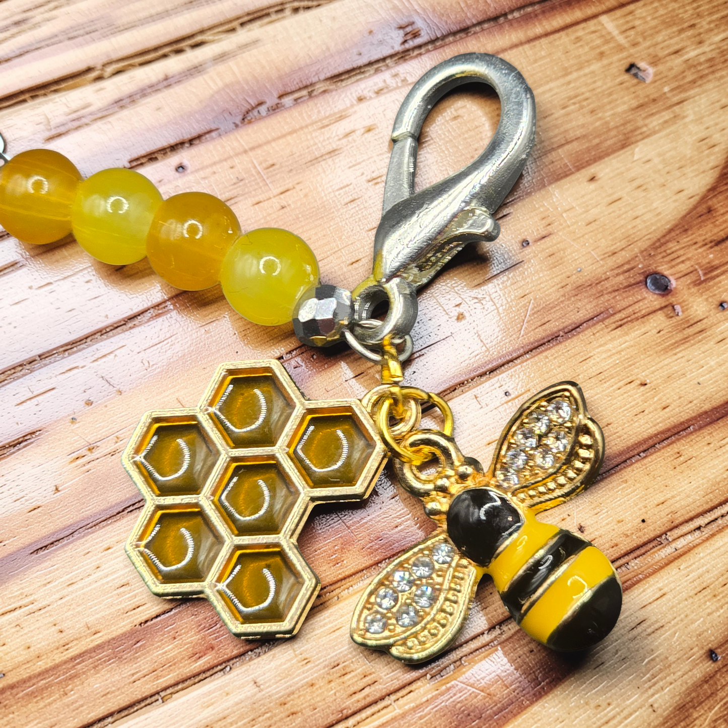 close up of the bee and honeycomb charm showing the rhinestone crystals on the bee wings