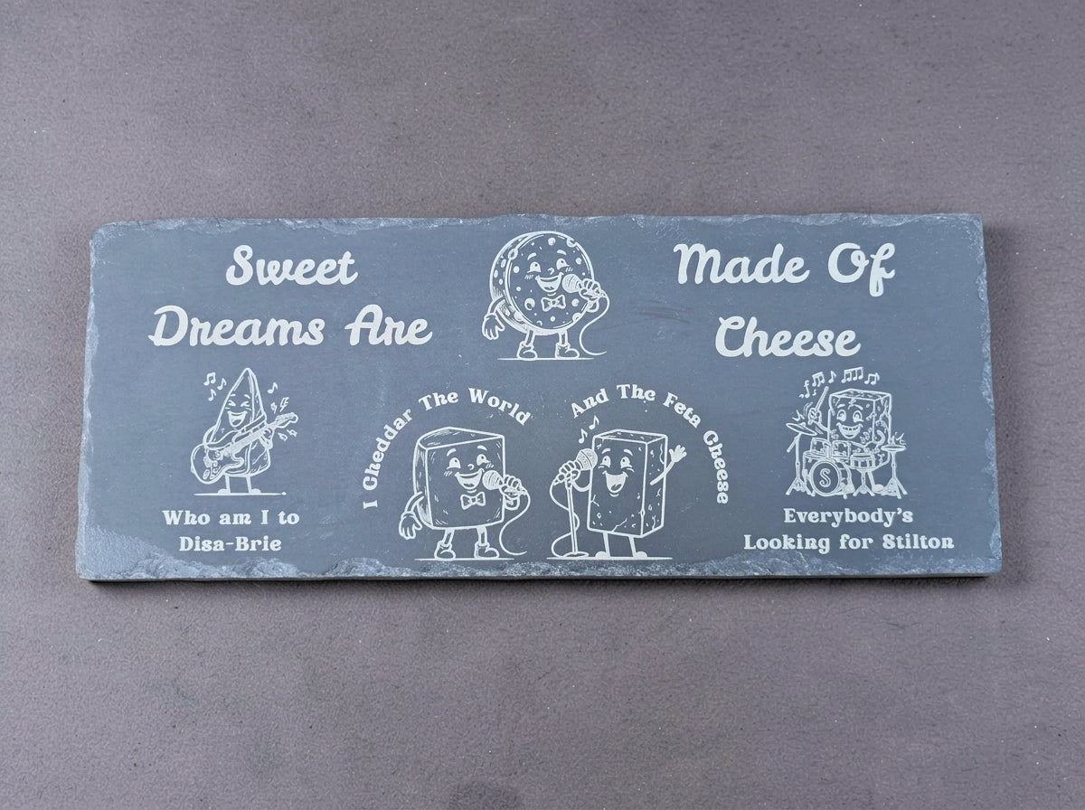 Rectangular slate board engraved with cartoon cheese characters and Sweet Dreams Are Made of Cheese song puns.