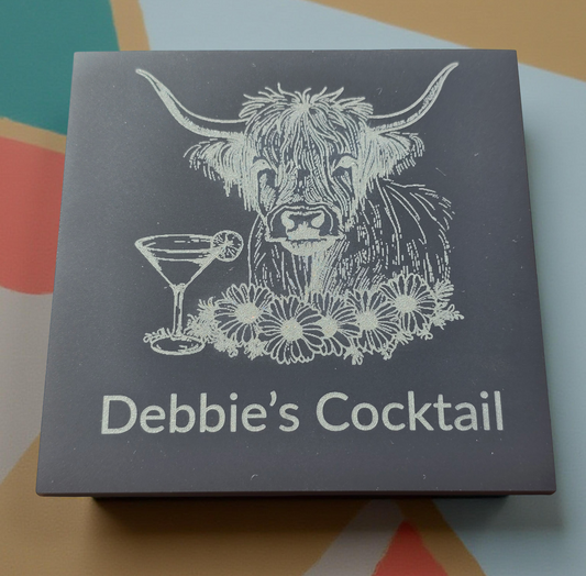 Box with a highland cow illustration and 'Debbie's Cocktail' text on a colorful background