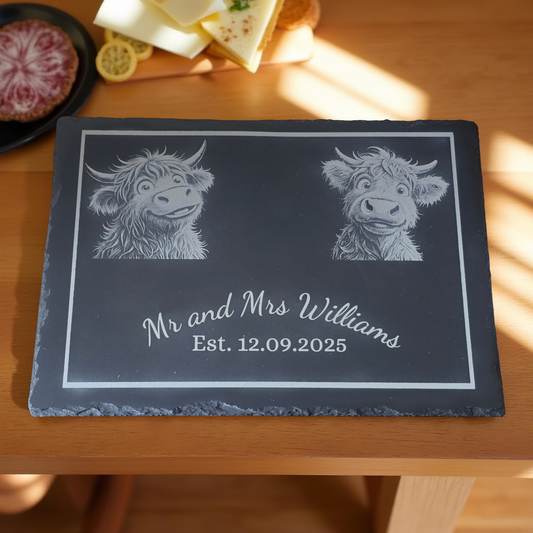 Cheese Slate with engraved cute highland cow designs and customised text on a wooden surface