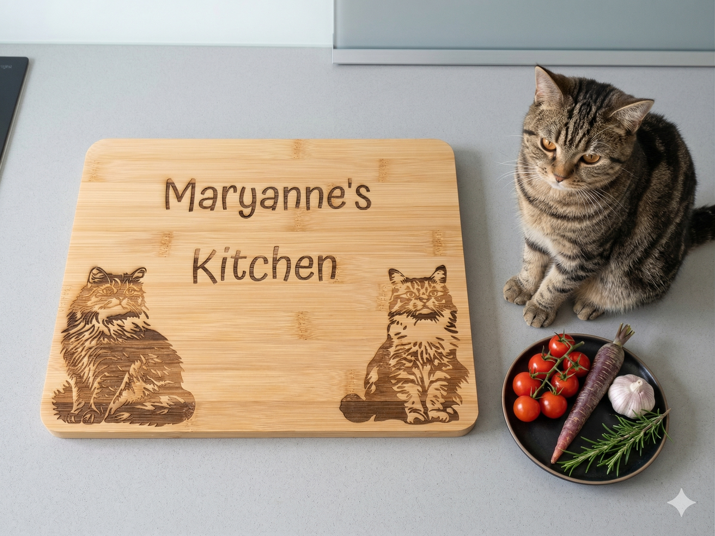 personalised chopping board with name and cat engravings on a kitchen worktop. a sitting cat rests next to the chopping board