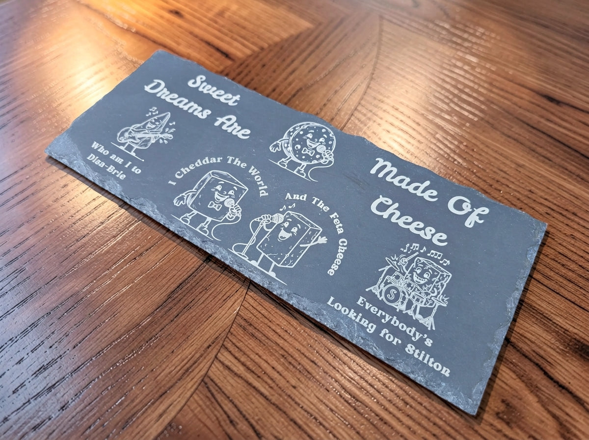 Dark slate board engraved with cartoon cheese musicians and Sweet Dreams Are Made of Cheese song parody lyrics.