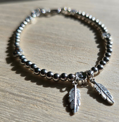 Feather and Flower Silver Beaded Bracelet - Silver beaded chain with daisy beads and leaf charms