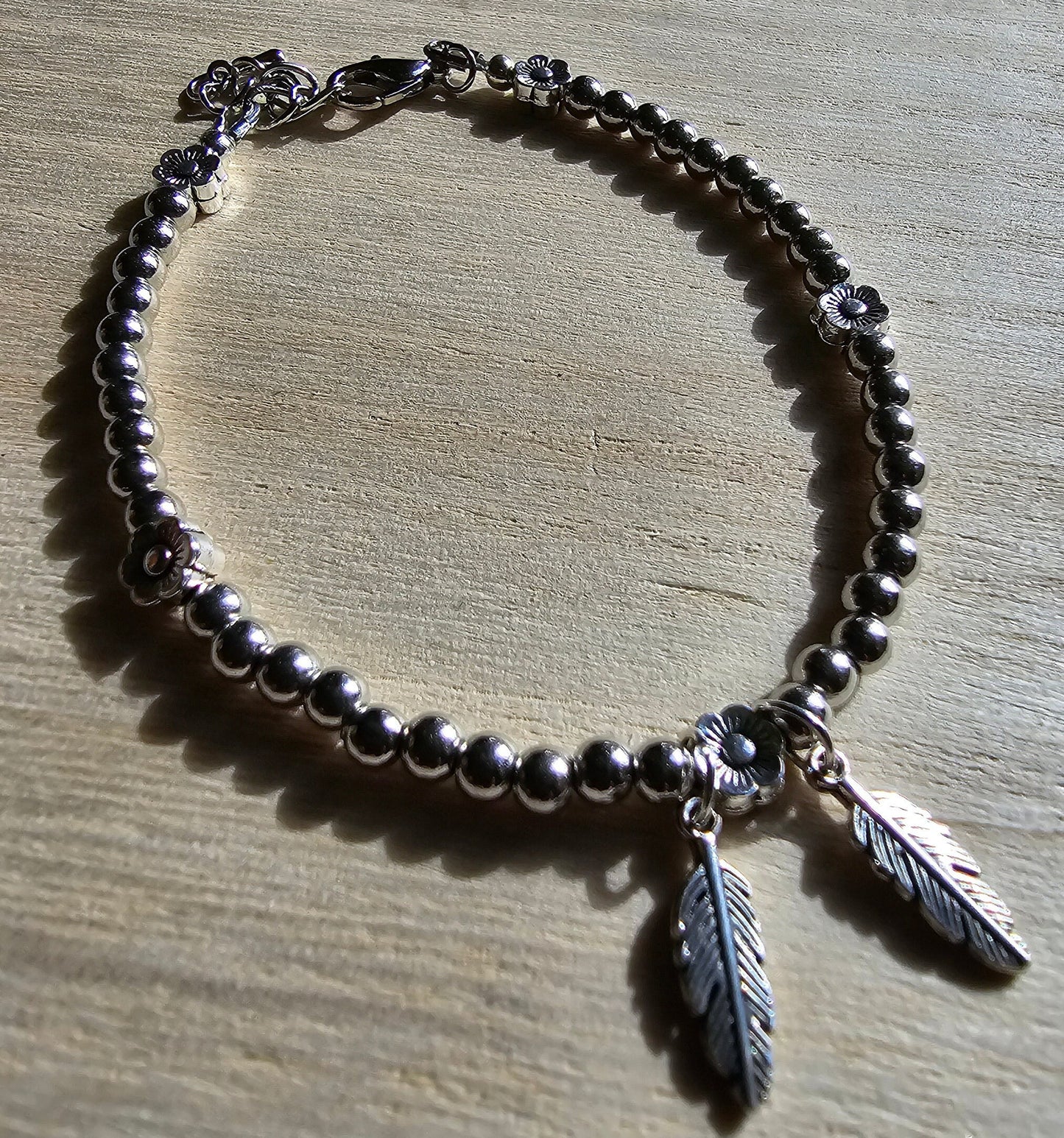 Feather and Flower Silver Beaded Bracelet - Silver beaded chain with daisy beads and leaf charms