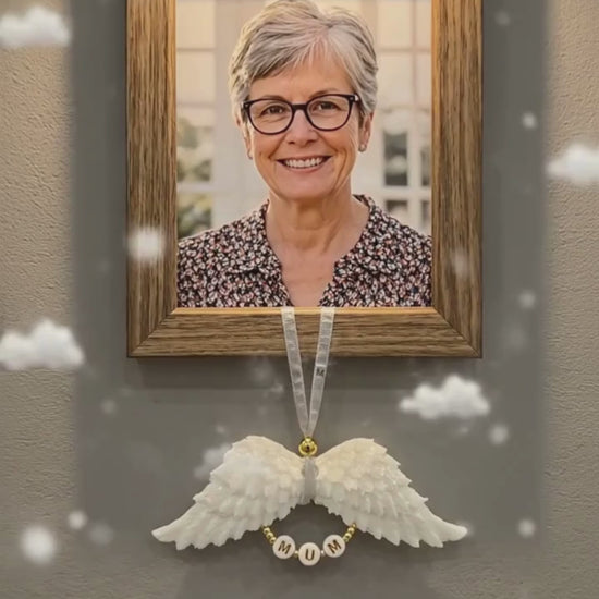 White resin angel wing with mum lettering hangs from a portrait picture of a lady